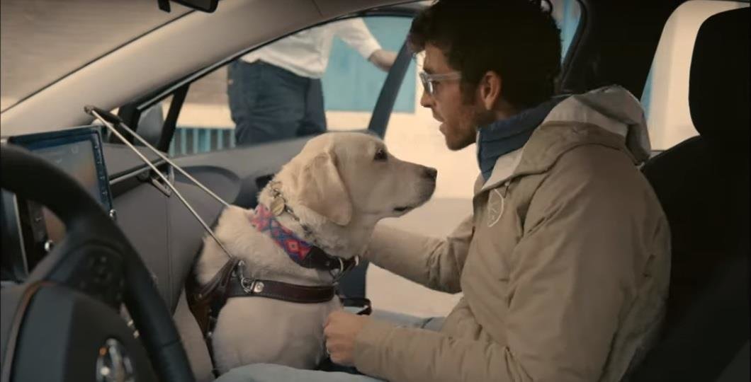 Una persona ciega, con discapacidad visual, usa viaja como copiloto en un coche de Cabify.