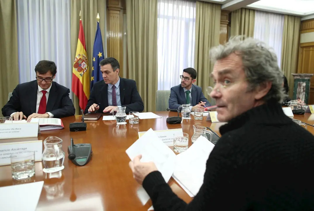 El ministro de Sanidad, Salvador Illa (1i), habla con el presidente del Gobierno, Pedro S&aacute;nchez (2i), acompa&ntilde;ados del director del Centro de Coordinaci&oacute;n de Alertas y Emergencias Sanitarias del Ministerio de Sanidad, Fernando Sim&oacute;n (frente a S&aacute;nchez)
