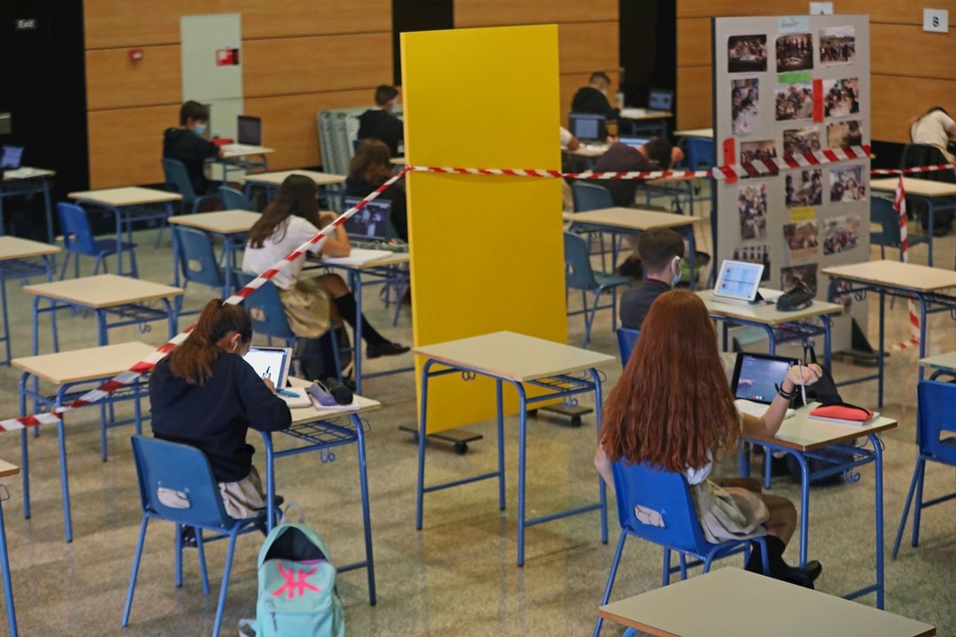 Alumnos atienden desde su ordenador clases virtuales impartidas en un colegio. Archivo