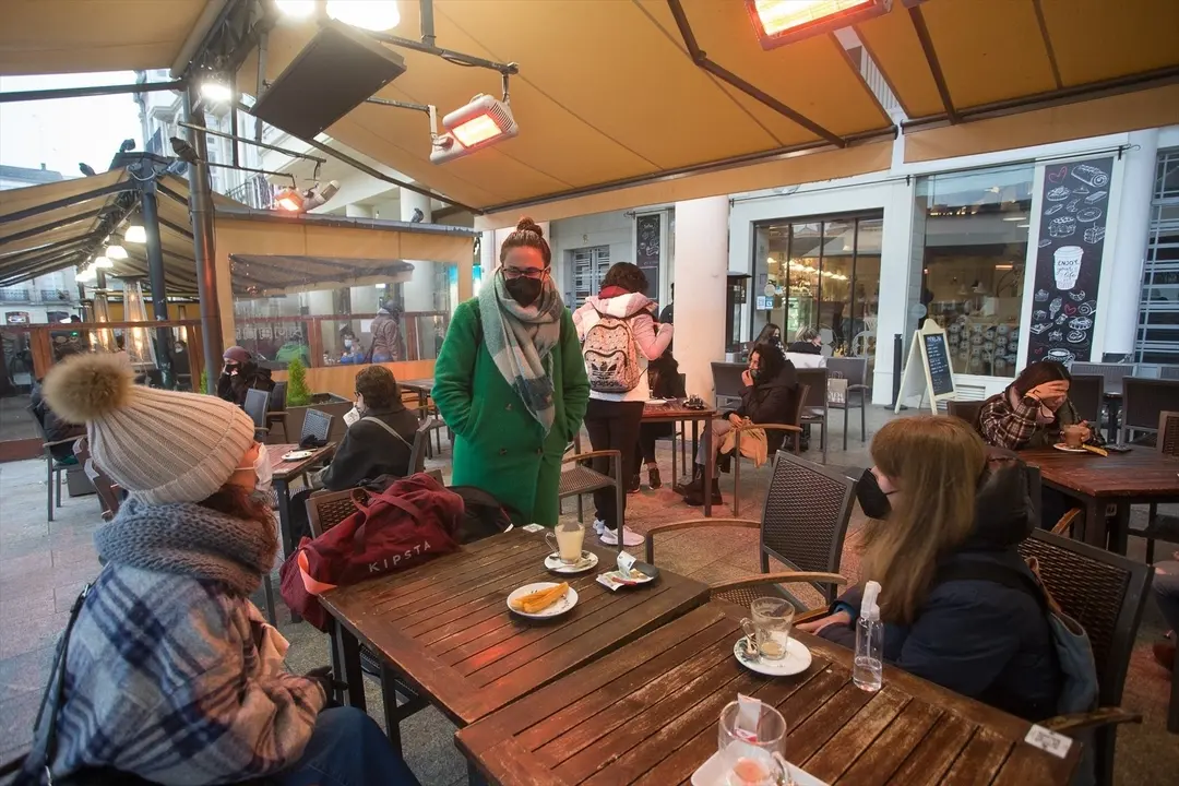 Tres chicas en la terraza de un restaurante el primer d&iacute;a del cierre perimetral decretado en Lugo, Galicia (Espa&ntilde;a), a 15 de enero de 2021. El cierre perimetral forma parte del paquete de nuevas restricciones de la Xunta para frenar la expansi&oacute;n del virus