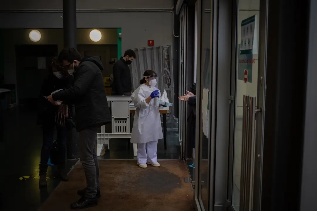 Archivo - Una trabajadora echa gel desinfectante a un votante a su llegada una mesa electoral en Antic Convent St. Agust&iacute; en Barcelona, Catalu&ntilde;a (Espa&ntilde;a), a 14 de febrero de 2021. La jornada electoral transcurrir&aacute; con protocolos de seguridad ante el Covid