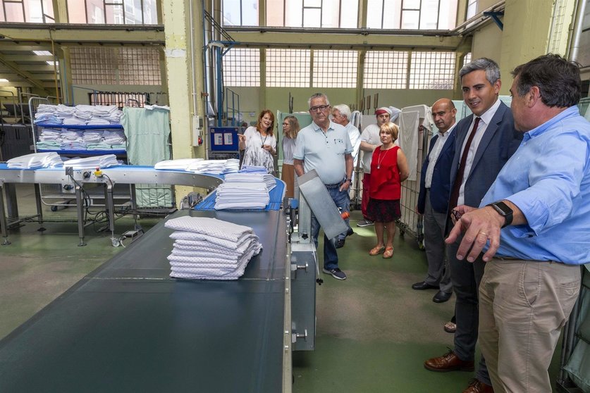 El vicepresidente y portavoz del Gobierno de Cantabria, Pablo Zuloaga, visita la lavanderia industrial de AMICA en el polígono de La Cerrada en Maliaño (Camargo), junto a integrantes de la Directiva de la asociación