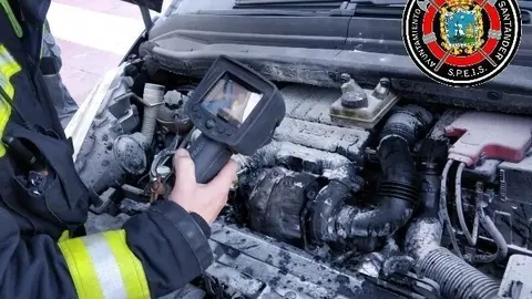 Bomberos de Santander revisan un veh&iacute;culo incendiado
