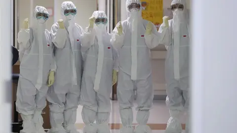 Trabajadores m&eacute;dicos con trajes de seguridad para atender a enfermos por coronavirus.
