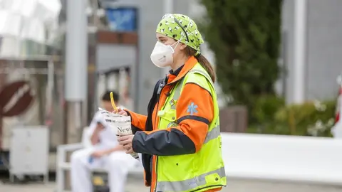 Una trabajadora sanitaria protegida con mascarilla sostiene un tentempi&eacute; en las inmediaciones del Hospital de Campa&ntilde;a de IFEMA donde trabajan a destajo para cuidar de todas personas con Covid-19 que est&aacute;n ingresadas en el recinto.