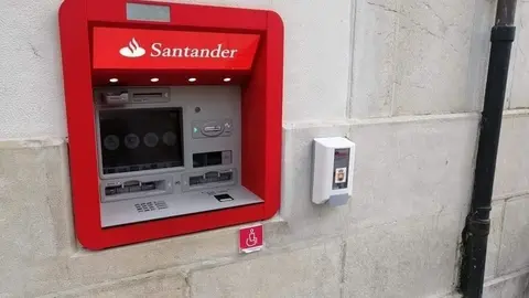 Dispensador de gel hidroalcoh&oacute;lico junto a un cajero autom&aacute;tico de una banco