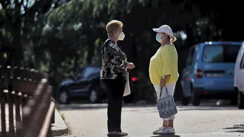 Dos mujeres protegidas con mascarilla mantienen una conversaci&oacute;n en una de las calles del municipio de Gri&ntilde;&oacute;n (Madrid) durante el d&iacute;a 69 del estado de alarma decretado a consecuencia del coronavirus y todav&iacute;a fase 0 de la desescalada instaurada por el Gob