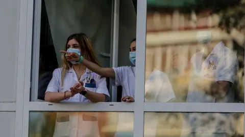 Sanitarios aplauden desde una ventana de del Hospital Fundaci&oacute;n Jim&eacute;nez D&iacute;az cuando en la Fase 1 de la desescalada contin&uacute;an los aplausos en homenaje a los profesionales sanitarios. En Madrid (Espa&ntilde;a) a 25 de mayo de 2020.