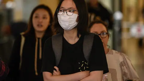 A woman wearing a protective face mask seen in Sydney, Wednesday, March 4, 2020.  (AAP Image/James Gourley) NO ARCHIVING