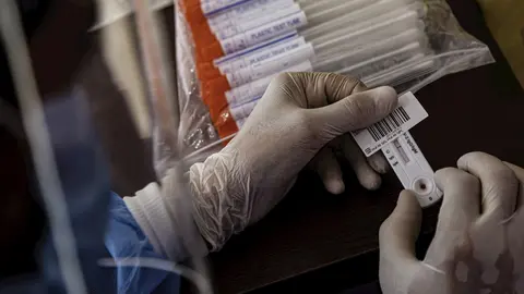 16 June 2020, Egypt, Cairo: A health worker holds swab samples collected from people at a drive-through coronavirus (COVID-19) testing unit inside the parking lot of Ain Shams University Specialized Hospital.