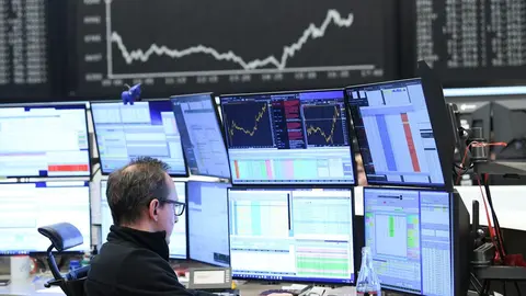 16 March 2020, Frankfurt/Main: A stock trader sits in front of his monitors in the trading room of the Frankfurt Stock Exchange. As a result of the worsening coronavirus crisis, the German share index Dax has fallen below the 9000 point mark. Photo: Arne 