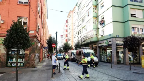 Empleados de la limpieza caminan por las calles del barrio La Inmobiliaria de Torrelavega