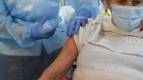 Una mujer de la Llar d'Ancians del IMAS recibe la primera dosis de la vacuna contra el coronavirus.