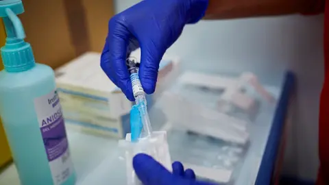 Un sanitario de Cruz Roja se prepara para administrar la vacuna contra la gripe en un punto de vacunaci&oacute;n instalado en Aranjuez, Madrid (Espa&ntilde;a), a 12 de noviembre de 2020. La Comunidad de Madrid ha vacunado este 2020 a cerca de 845.000 madrile&ntilde;os frente 