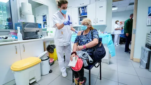 Una sanitaria vacuna a una mujer sin hogar en el Centro de Acogida Municipal Para Personas Sin Hogar San Isidro, a 20 de mayo de 2021, en Madrid (Espa&ntilde;a). La visita coincide con el inicio de la vacunaci&oacute;n para personas sin hogar en los centros municipales