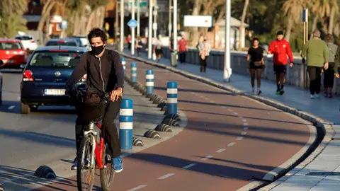 Archivo - Un grupo de personas practican deportes al aire libre con mascarillas 