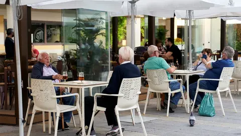 Varias personas en la terraza de una cafeter&iacute;a de M&oacute;stoles el mismo d&iacute;a en que la Comunidad de Madrid ha indicado que a partir del pr&oacute;ximo lunes, 31 de mayo, disminuir&aacute;n las restricciones en este sector, a 26 de mayo de 2021, en M&oacute;stoles, Madrid, (Espa&ntilde;a)