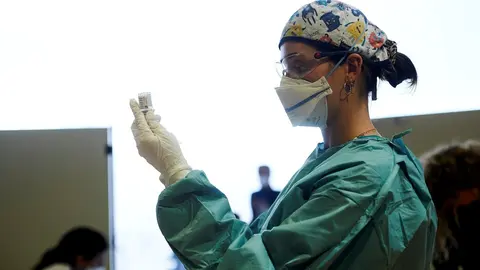 Archivo - Una profesional sanitaria sostiene un vial