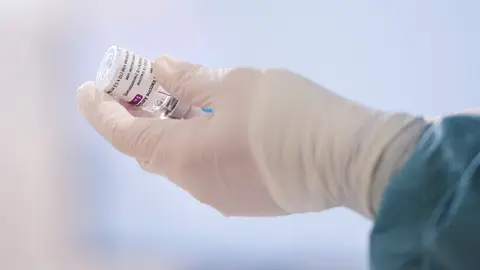 Archivo - Una profesional sanitaria sostiene un vial con la vacuna 