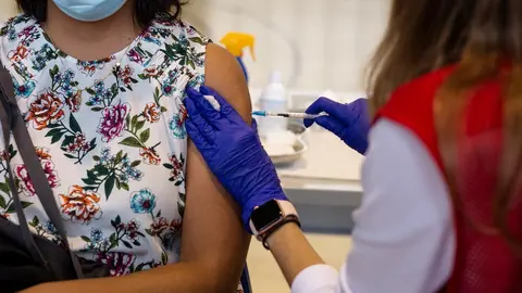 Una voluntaria de Cruz Roja administra una dosis de la vacuna contra el Covid-19 a un estudiante universitario en el campus de Ciudad Universitaria, a 14 de septiembre de 2021, en Madrid, (Espa&ntilde;a). Hoy arranca en la Comunidad de Madrid la vacunaci&oacute;n frent