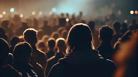 Back view of crowd of fans watching live concert performance (3)