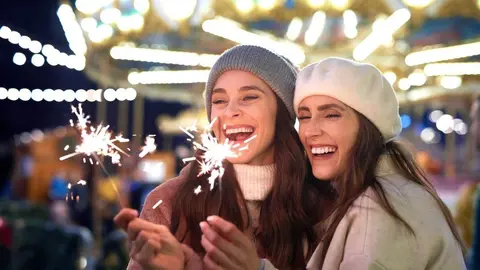 Best friends with sparklers on Christmas market
