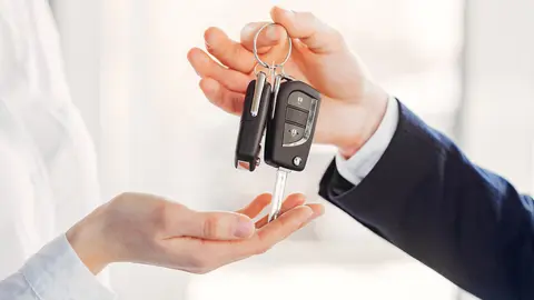 Woman buying the car. Lady in a car salon. Manager with a client