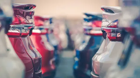 Cars For Sale. Automotive Industry. Cars Dealership Parking Lot. Rows of Brand New Vehicles Awaiting New Owners.